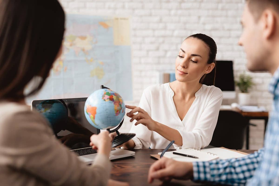 A professional travel consultant discusses global travel destinations with clients using a world globe during a personalized travel planning session. The image highlights expert travel advice, customized vacation planning, destination recommendations, and seamless trip organization, making it ideal for content about Group Vacation Planning, family vacations, travel agencies, and personalized travel experiences.