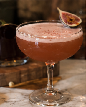 Fig mezcal sour in coupe glass
