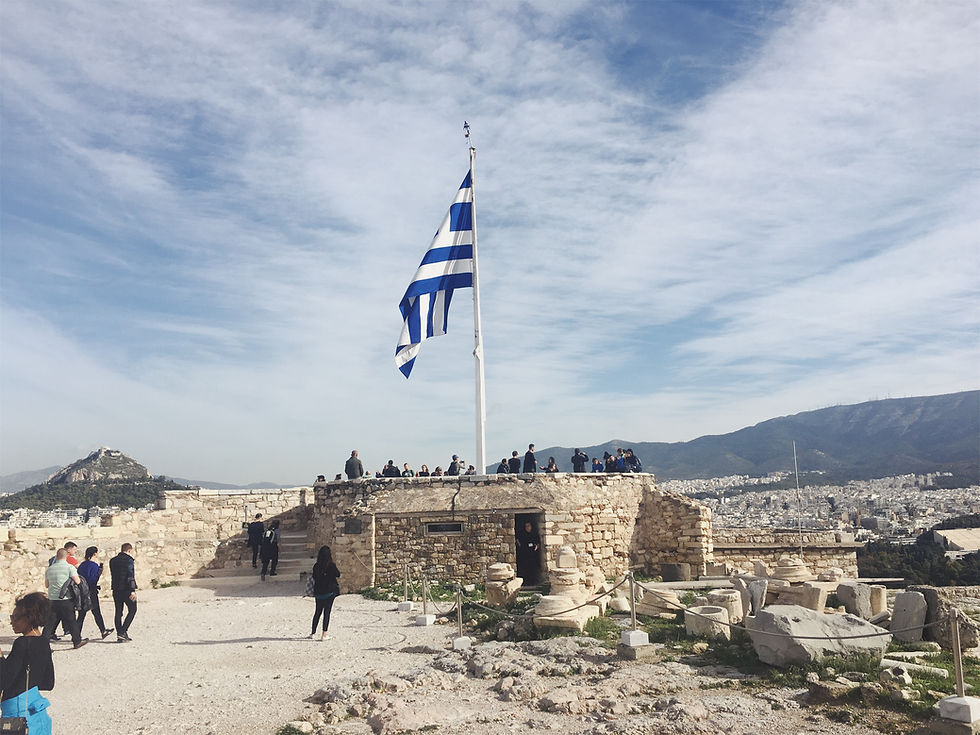 The Greek flag soaring high above Acropolis
