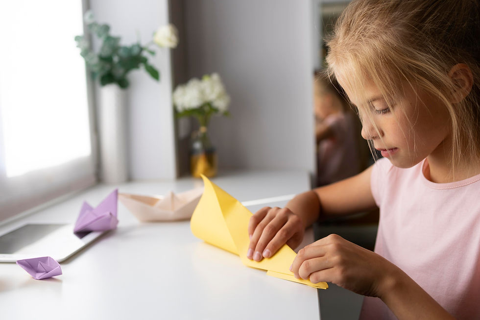 little-girl-playing-with-origami-paper-home.jpg