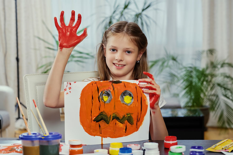 cute-little-girl-holds-poster-with-painted-halloween-pumpkin.jpg
