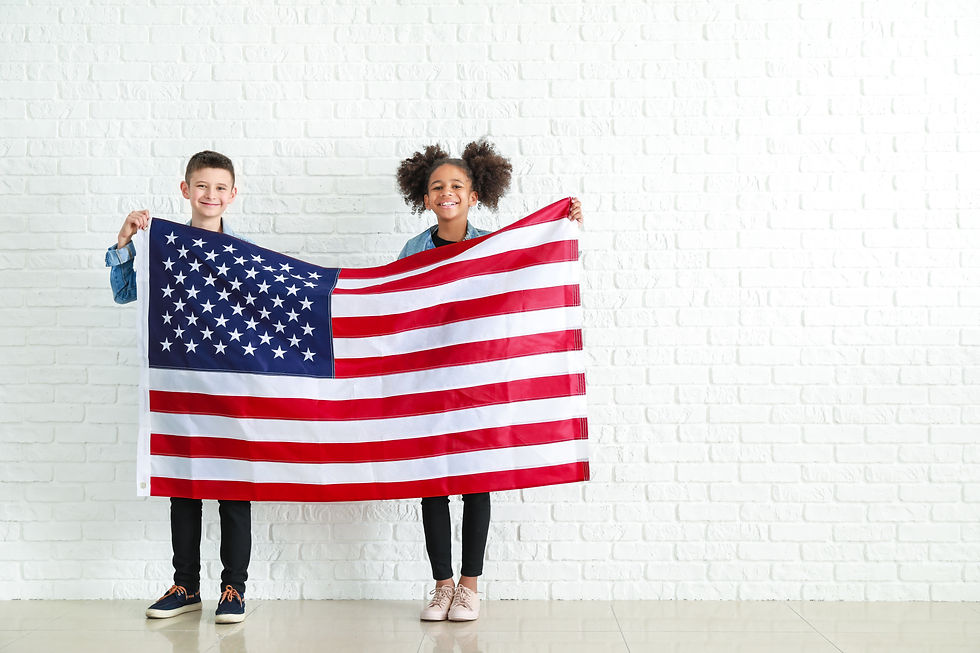 cute-children-with-national-flag-usa-near-white-brick-wall.jpg