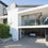Thumbnail: Elegant gated entrance leading up to a grand real estate property.

