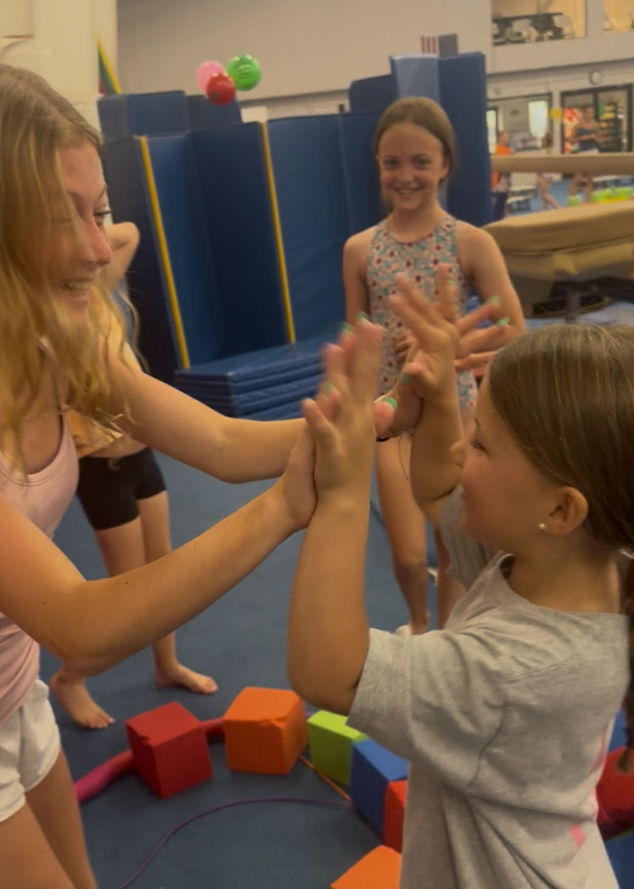 two girls high fiving