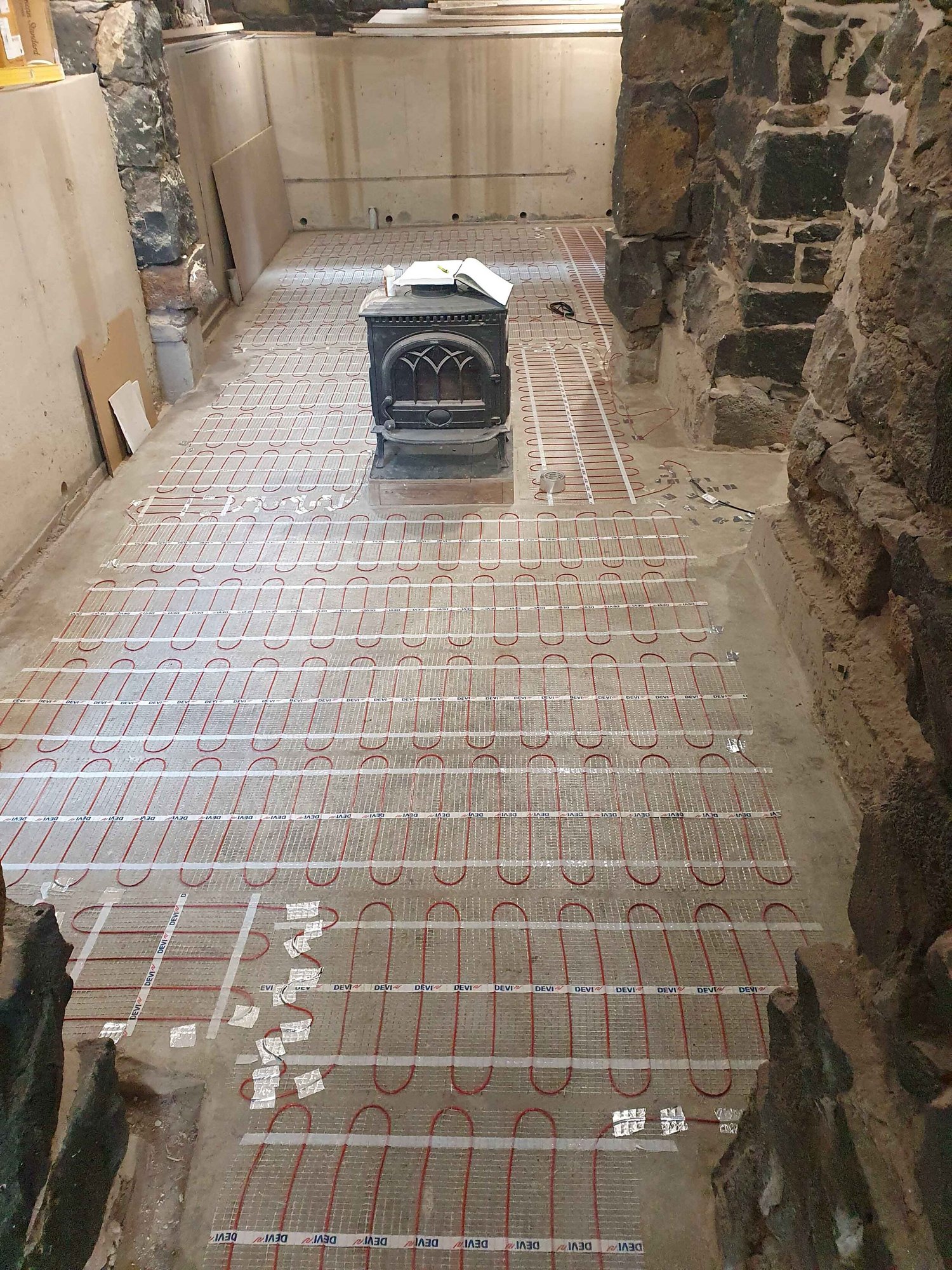 Wine cellar converted to living space with floor heating