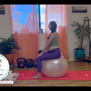 Pregnant woman on birth ball and yoga mat to prepare for birth