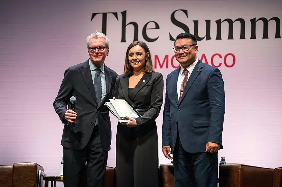 Arnaboldi (left), of Frette, and Randy Santos (right), president of Les Clefs d’Or International, honor Benhaim.Forbes Travel Guide