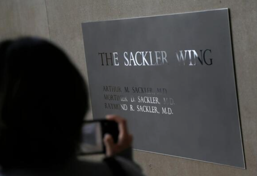 A sign with some names of the Sackler family is displayed at the Metropolitan Museum of Art Jan. 17, 2019, in New York. (AP Photo/Seth Wenig, File)