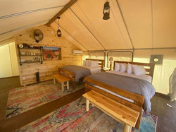 Two beds inside a tent for tent glamping at East Zion Resort near Zion National Park