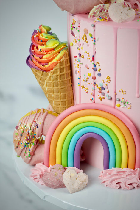 Pink drip cake with sweets 