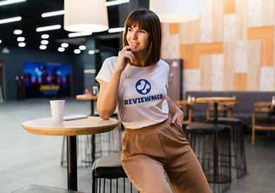Brunette woman wearing a T-shirt sitting near the little table_Page 1_2 from reviewmed (18