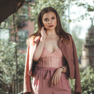 portrait of brunette model in pink outfit in the park