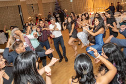 Candid event photography capturing guests dancing and celebrating on the dance floor in Merseyside.