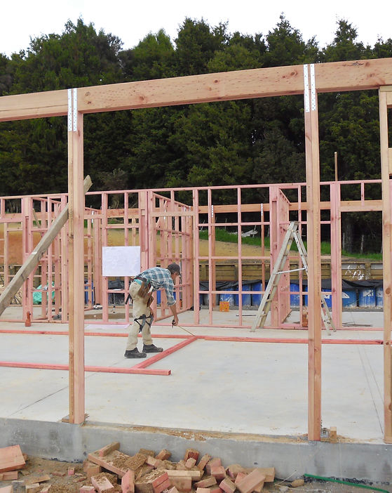 Timber Framed House with Poured concrete pad all under construction.