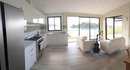 A new kitchen in a newly built house feature large windows look out onto a peaceful bay in Northland New Zealand.