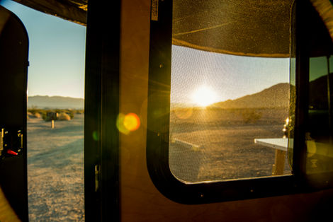 A photo of a sunrise from a teardrop camper in a national park during an outdoor lifestyle photoshoot. Taken by Philadelphia based photographer Joshua Dahl.