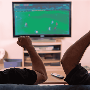 Two friends happily watching a Football match on TV