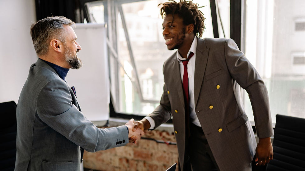 Two men happily shaking hands