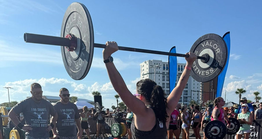 a woman lifting a barbell overhead