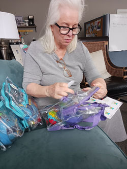 Dr. Harum fills Sensory Bags for the Special Needs Community
