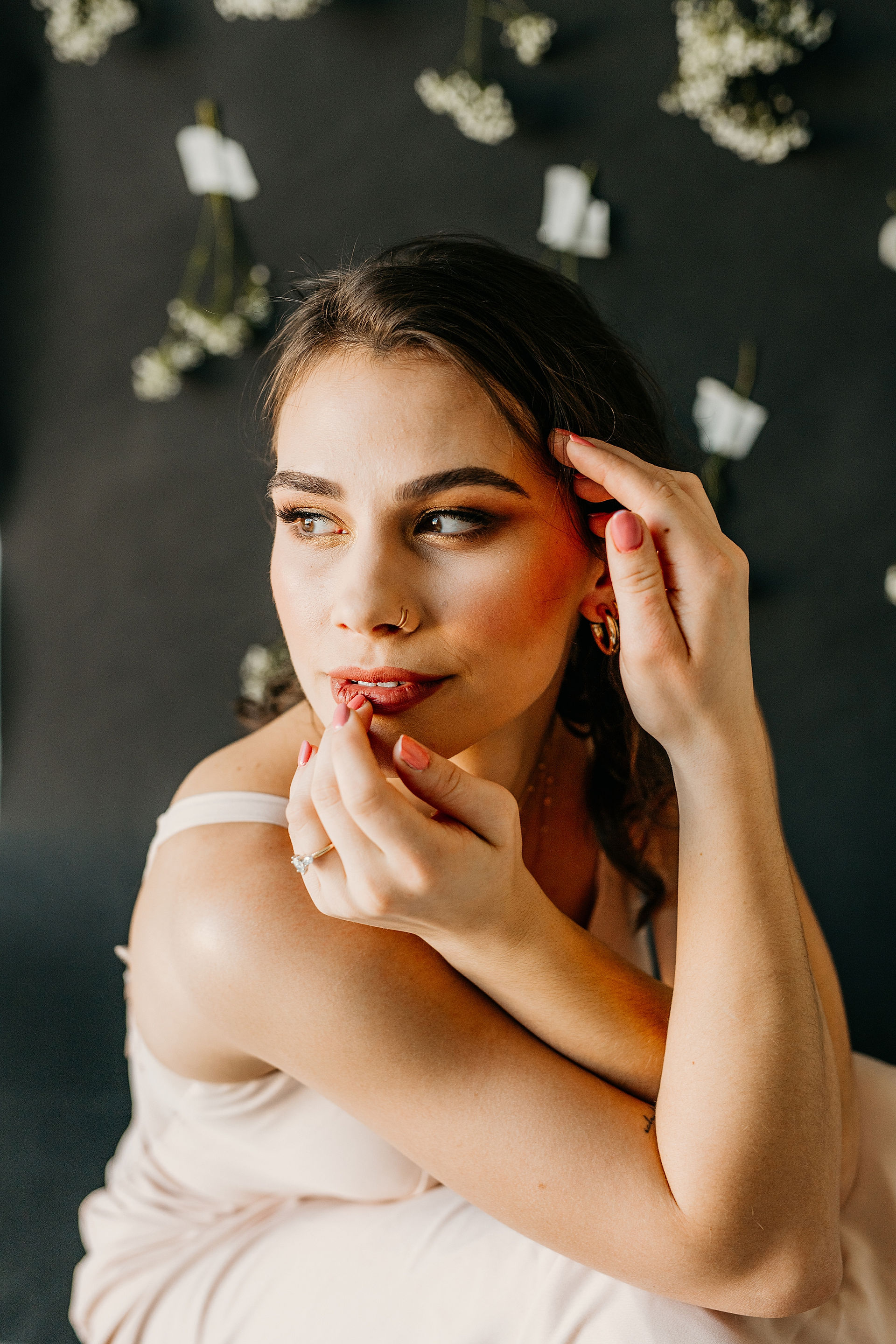 model framing her face with her hands