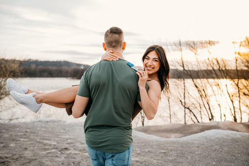 Man walking away holding woman while she shows pregnancy test