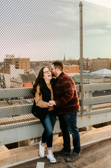 couple laughing on top of parking garage