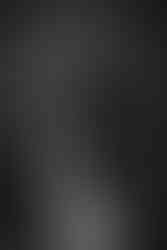 black and white image of bride snuggling into groom's chest