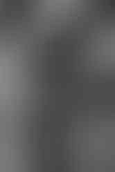 Black and white photo of couple holding baby bump