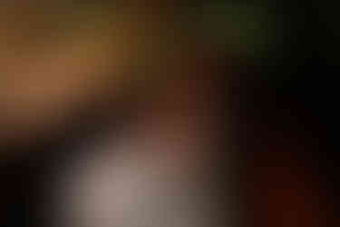 bride laying in groom's lap in truck bed by candle light