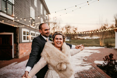 Bride and groom linking hands and laughing
