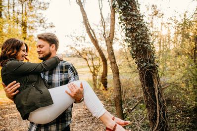 guy holding girl in his arms and laughing