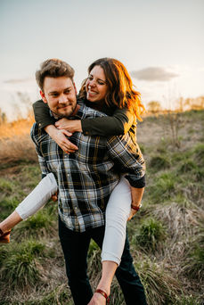 couple giggling during piggy back ride
