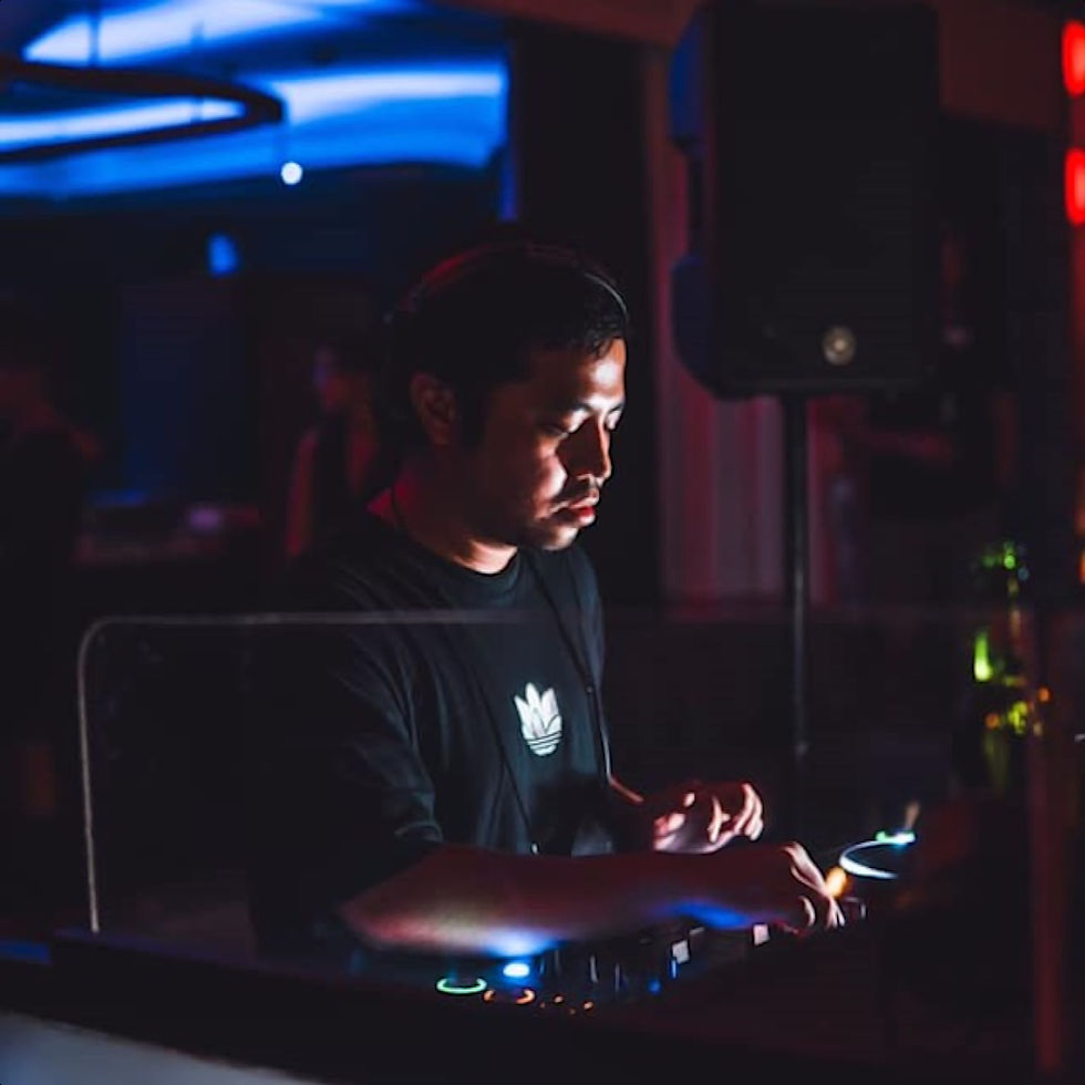 Indonesian DJ and producer Nandi performing at an event, colour image.