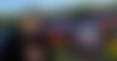 French DJ and videographer DJ Phoenixx posing in front of a wall adorned with Halloween graffiti, captured in a color image