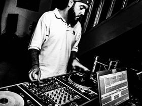 French dJ and producer DJ King Flow performing at an event, black and white image.