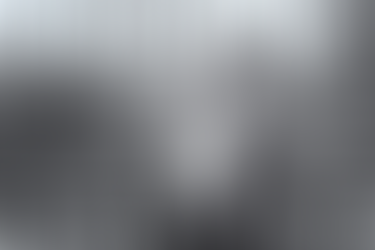 Italian DJs and producer Bicycle Corporation standing in front of fence with a bike chained to it, black and white image image.