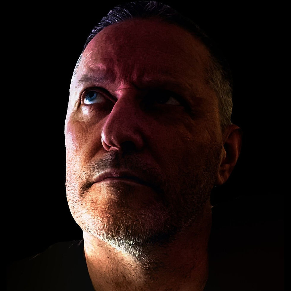 Scottish DJ and producer Gowzer in a head shot lookimng up slightly with his head turned to the right, colour image.