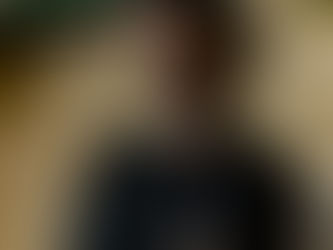 Argentinian DJ and producer Matias Gauna is performing during a DJ set, wearing headphones and a black T-shirt while focused on mixing music in a club setting.