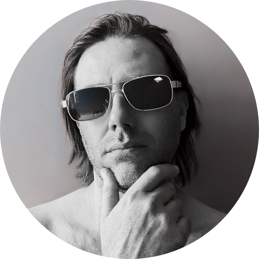 British DJ and Producer Blaze UK in a heashot image with his hand on hi chin and wearing sunglasses, black and white image.