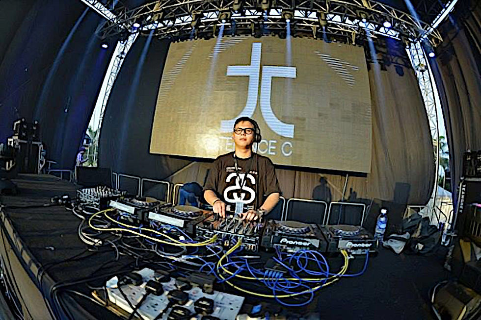 Malaysian DJ and producer Terence C performing at an event, colour image.