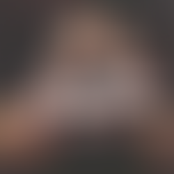 Portrait of Charlie (US), Phoenix-based DJ originally from Oregon, adjusting sunglasses while standing in front of a seat, wearing a black, red and white jacket.