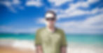 Portuguese DJ Joshua standing on a beach in Portugal wearing sunglasses, colour image.