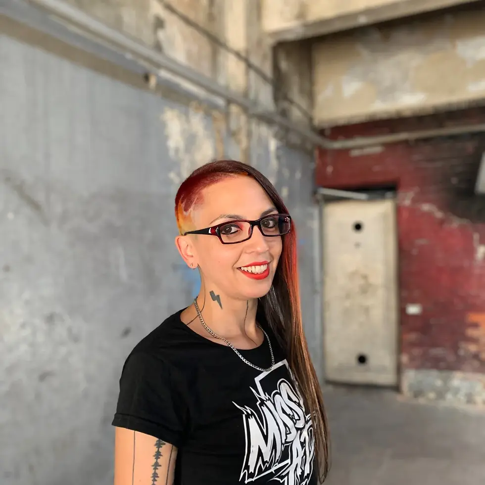 Argentinian DJ and producer Miss Adk standing smiling at camera, colour image.