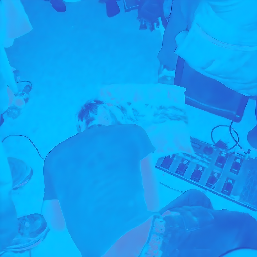 Blue-tinted promotional image for Yushka’s House Party show showing a person asleep on the floor at a house party, surrounded by people, chairs and audio equipment.