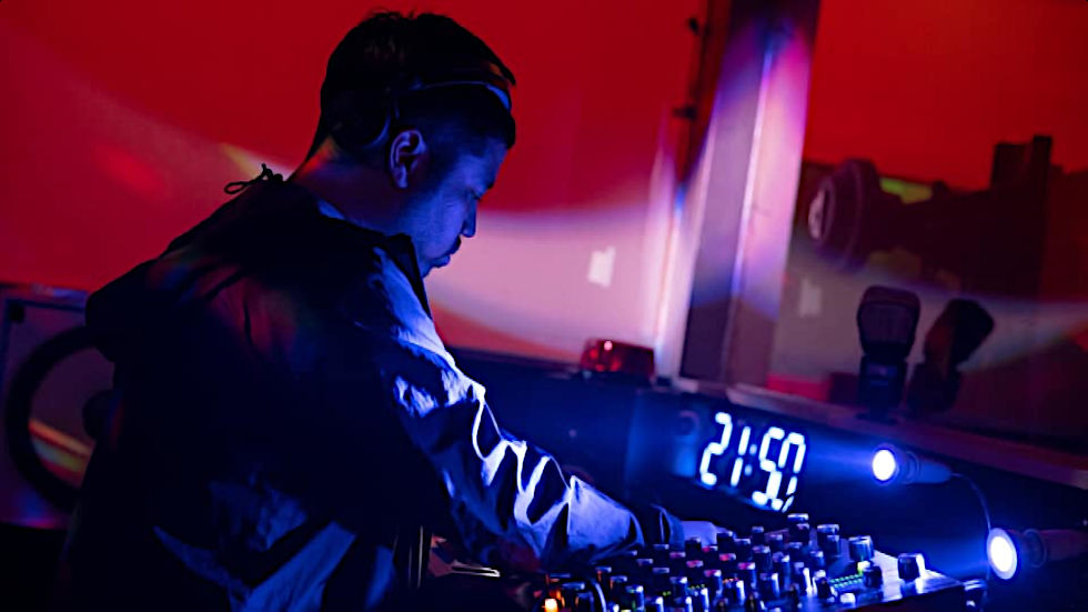 Indonesian DJ and Produccer Nandi performing in the studio, colour image.