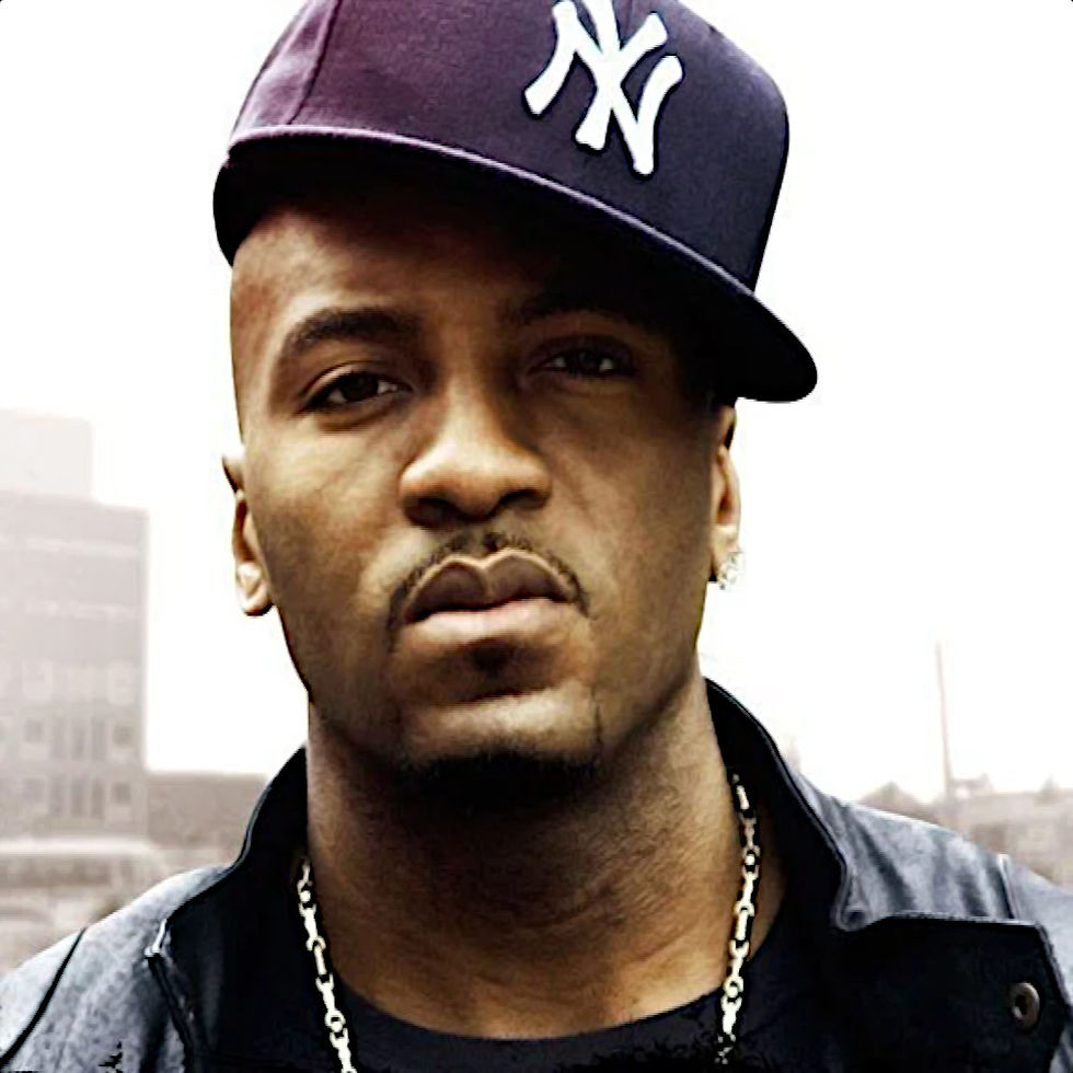 American rapper and producer Grafh wearing a New York baseball cap slanted to the side in a profile shot, colour image.