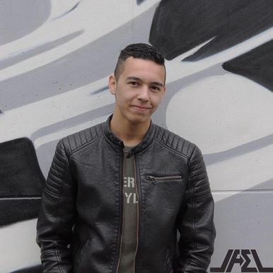 Portrait of Christian Tyler wearing a black leather jacket in front of a monochrome graffiti wall, representing the The Hague-based DJ and producer whose sound sits within Melodic House and Deep House.