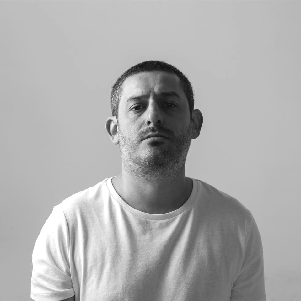 Turkish DJ and Producer Sinan Arsan in upper body shot looking directly at camera, black and white image.