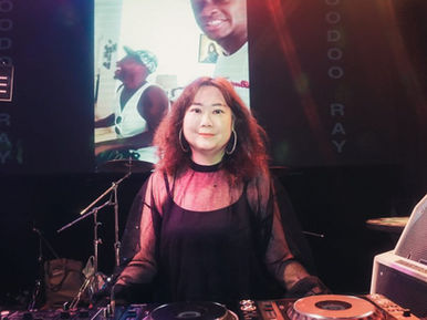 Taiwanese DJ Ingry performing at Just House Taiwan, looking at the camera and smiling in a colour image.